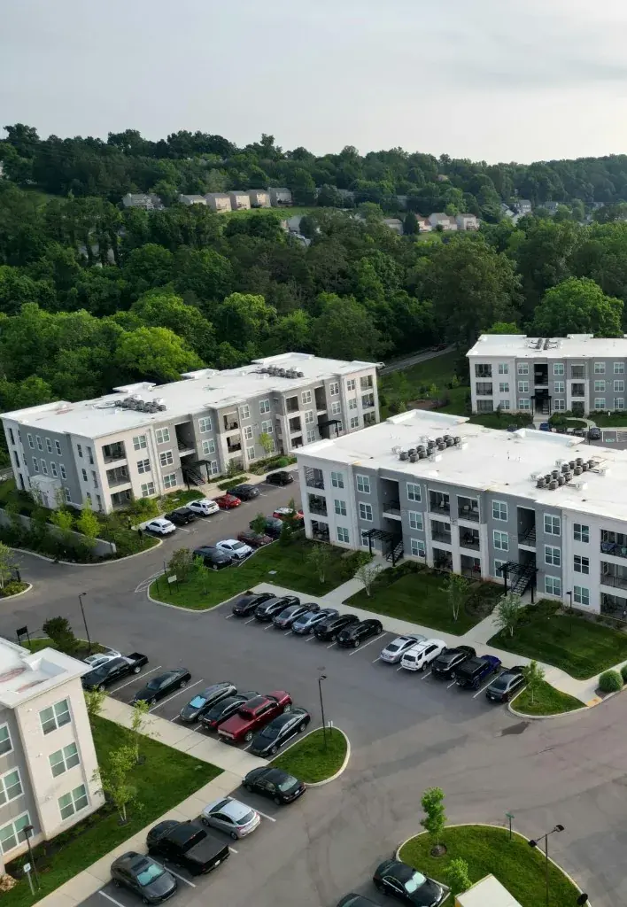 A residential building's parking area with visitor and resident spaces